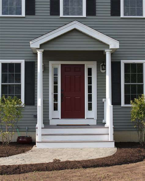 gray house with burgundy door.